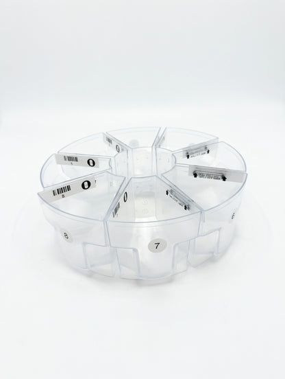 Set of clear plastic MedaCube bin containers with numbered labels on a white background laid out in a circle