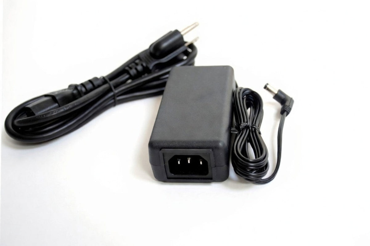 Black power adapter with cables on a white background